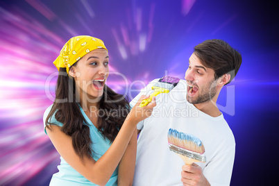 Composite image of happy young couple painting together and laug