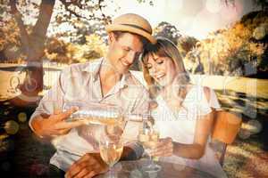 Cute couple drinking white wine together outside