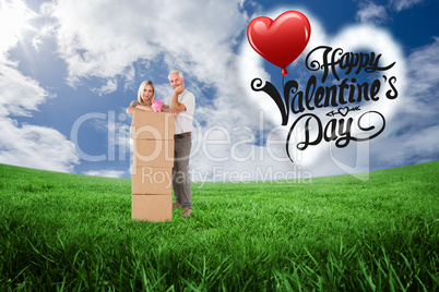 Composite image of happy couple leaning on pile of moving boxes