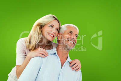 Composite image of smiling couple embracing and looking