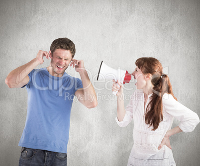 Composite image of woman shouting through a megaphone