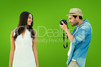 Composite image of handsome hipster taking a photo of pretty gir