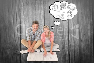 Composite image of attractive young couple sitting looking at bl