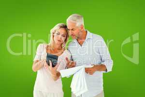 Composite image of anxious couple working out their bills