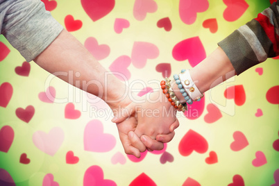 Composite image of students holding hands