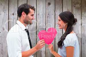 Composite image of pretty brunette giving boyfriend her heart
