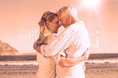 Happy couple on the beach touching faces