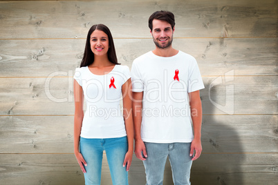 Composite image of attractive young couple wearing aids awarenes