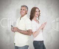 Composite image of casual couple sending text messages