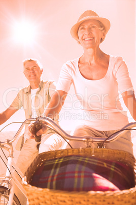 Happy senior couple going for a bike ride