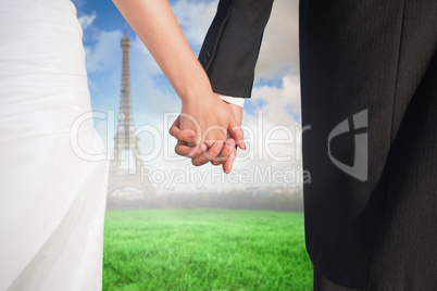 Composite image of close up of cute young newlyweds holding thei