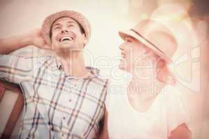 Young hip couple laughing on bench