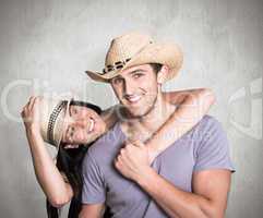 Composite image of couple in matching straw hats