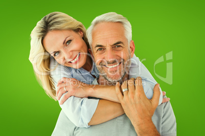 Composite image of happy couple standing and hugging