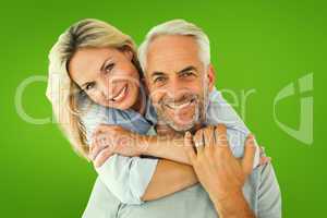 Composite image of happy couple standing and hugging