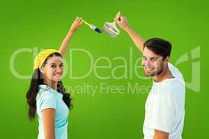 Composite image of happy young couple painting together