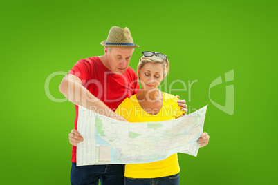 Composite image of lost tourist couple using map