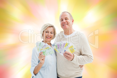 Composite image of happy mature couple smiling at camera showing