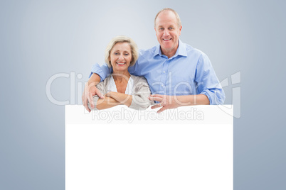 Composite image of mature couple smiling at camera