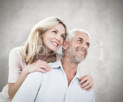 Composite image of smiling couple embracing and looking