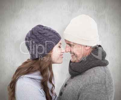 Composite image of couple in warm clothing facing each other