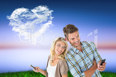 Composite image of attractive couple using their smartphones