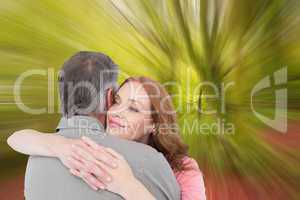 Composite image of casual couple hugging each other