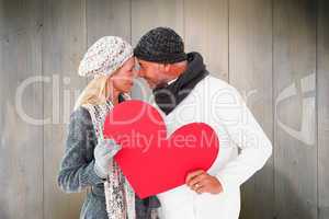 Composite image of smiling couple in winter fashion posing with