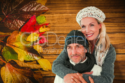 Composite image of happy couple in winter fashion embracing