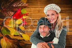 Composite image of happy couple in winter fashion embracing