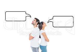 Composite image of happy couple standing looking up