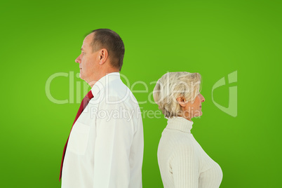 Composite image of older couple standing not facing each other