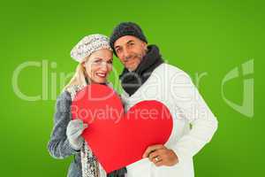 Composite image of smiling couple in winter fashion posing with