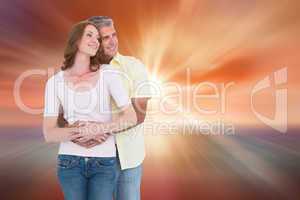 Composite image of casual couple hugging and smiling