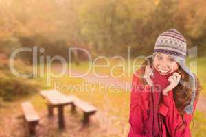 Composite image of cold redhead wearing coat and hat