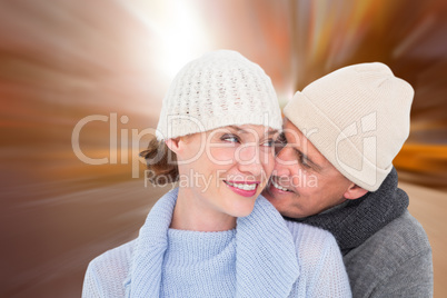 Composite image of casual couple in warm clothing