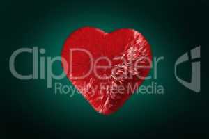 Deep red heart on green background