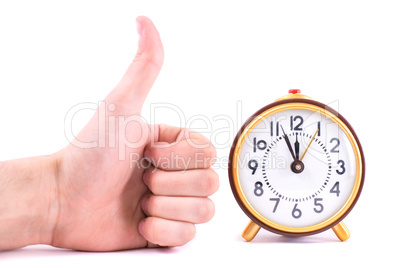 Alarm clock and hand isolated on white