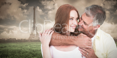 Composite image of casual couple smiling and hugging