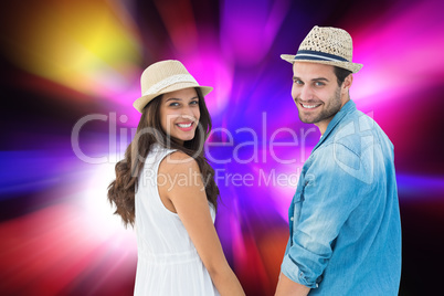 Composite image of happy hipster couple holding hands and smilin