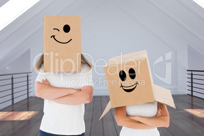 Composite image of mature couple wearing boxes over their heads