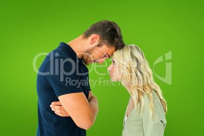 Composite image of young couple standing head to head