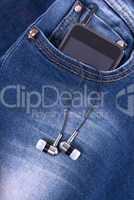 MP3 player and earphones sticking out of jeans pocket