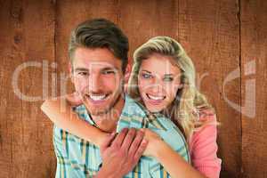 Composite image of attractive couple embracing and smiling at ca