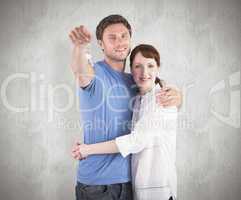 Composite image of couple holding keys to home