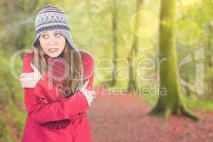 Composite image of cold redhead wearing coat and hat