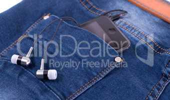 MP3 player and earphones sticking out of jeans pocket