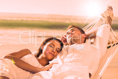 Peaceful couple napping in a hammock