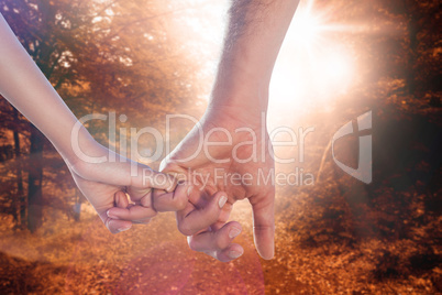 Composite image of loving young couple holding hands