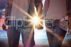 Composite image of hip young couple holding hands